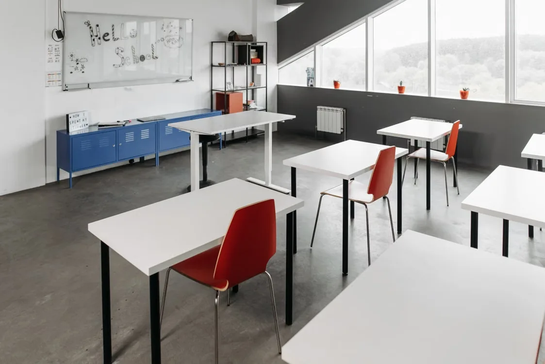 Illustrative photograph of a school classroom with desks and painted walls; not a G Munn & Son project
